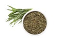 Bowl of dry tarragon and fresh leaves isolated on white, top view Royalty Free Stock Photo