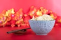 A bowl of dumplings and a pair of chopsticks on a red background Royalty Free Stock Photo