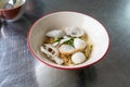 A bowl of egg noodle with variety of fish balls in Thai style on