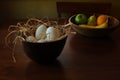 Bowl of eggs and bowl of fruit on table Royalty Free Stock Photo