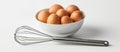 Bowl of Eggs With Whisk on White Background Royalty Free Stock Photo