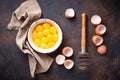 Bowl with eggs yolks and whisk