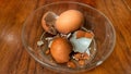 A bowl of eggshells sits on a wooden table. Royalty Free Stock Photo