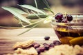 Bowl with extra virgin olive oil, olives, a fresh branch of olive tree and cretan rusk dakos close up.