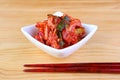 Bowl of Famous Korean Dish Kimchi with a Pair of Chopsticks on Wooden Table Royalty Free Stock Photo