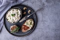 Bowl with fermented nut spread, slice of bread with cashew cheese