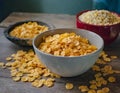 A bowl filled with corn flakes sits next to another bowl of petite flakes, ready for breakfast. The ground corn kernels offer a Royalty Free Stock Photo