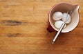 Bowl filled with eggs and whisk Royalty Free Stock Photo
