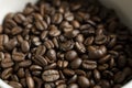 Bowl filled of fresh arabica or robusta coffee beans on a wooden table. Royalty Free Stock Photo