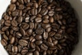 Bowl filled of fresh arabica or robusta coffee beans on a wooden table. Royalty Free Stock Photo