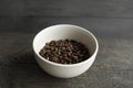 Bowl filled of fresh arabica or robusta coffee beans on a wooden table. Royalty Free Stock Photo