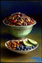 A Bowl Filled With Fruit And Nuts Next To Another Bowl Filled With Nuts. Generative AI