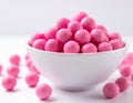 Bowl Filled With Pink Candy Balls. A white bowl is filled with pink candy balls creating
