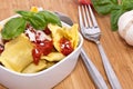 Bowl filled with Raviolis on wooden background Royalty Free Stock Photo
