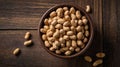 Roasted Peanuts in a Rustic Bowl on Dark Wood Table Top View Royalty Free Stock Photo