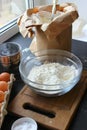 A bowl of flour and egg on the kitchen table Royalty Free Stock Photo