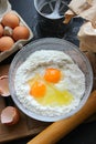 A bowl of flour and egg on the kitchen table Royalty Free Stock Photo