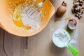 Bowl, flour, eggs and nuts on the wood desk. Royalty Free Stock Photo