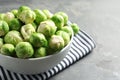 Bowl of fresh Brussels sprouts and napkin on table, closeup. Space for text Royalty Free Stock Photo