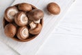 Bowl with fresh champignon mushrooms on wooden table, top view. Royalty Free Stock Photo