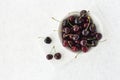 Bowl with Fresh Cherries on White Marble Board and Background Royalty Free Stock Photo