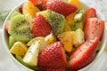 Bowl of fresh fruit salad, kiwi, apples, oranges