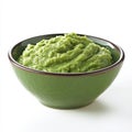 A bowl of fresh guacamole, isolated on a white background, emphasizing Royalty Free Stock Photo