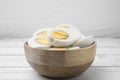 Bowl of fresh hard boiled eggs on white wooden table