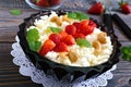 A bowl of fresh home-made cottage cheese with strawberries, mint and nuts Royalty Free Stock Photo