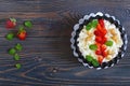 A bowl of fresh home-made cottage cheese with strawberries, mint and nuts Royalty Free Stock Photo