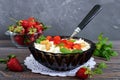 A bowl of fresh home-made cottage cheese with strawberries, mint and nuts Royalty Free Stock Photo