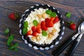 A bowl of fresh home-made cottage cheese with strawberries, mint and nuts Royalty Free Stock Photo