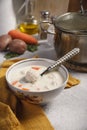 A bowl with fresh home made creamy soup with chiken meat bowls and a pot Royalty Free Stock Photo