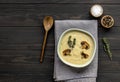 Bowl of fresh homemade mushroom cream soup on wooden table Royalty Free Stock Photo