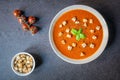 A bowl of fresh homemade organic tomato and basil soup with a side ramekin of croutons and a garnish of fresh tomatoes and basil Royalty Free Stock Photo