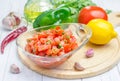 Bowl of fresh homemade salsa dip and ingredients