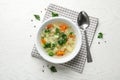 Bowl of fresh homemade vegetable soup served on white wooden table, flat Royalty Free Stock Photo