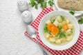 Bowl of fresh homemade vegetable soup served on white wooden table, flat lay Royalty Free Stock Photo