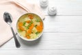 Bowl of fresh homemade vegetable soup served on white wooden table, flat lay Royalty Free Stock Photo