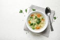 Bowl of fresh homemade vegetable soup  on white wooden table, flat lay. Space for text Royalty Free Stock Photo