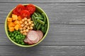 Bowl with fresh ingredients for vegetable salad on wooden table. Diet food Royalty Free Stock Photo