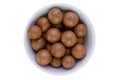 Bowl of fresh macadamia nuts with shells Royalty Free Stock Photo