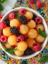 A bowl of fresh melon balls with raspberries and blackberries. Royalty Free Stock Photo