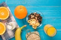 Bowl of fresh oatmeal porridge with banana and nuts on teal rustic table Royalty Free Stock Photo