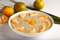 Bowl of fresh oatmeal porridge with orenges