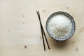 A bowl of fresh organic white Rice with Chinese sticks Royalty Free Stock Photo