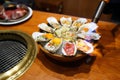 A bowl of Fresh Oyster topped with sea urchin roe uni, salmon roe ikura, wagyu beef, marinated egg yolk and spicy seafood Royalty Free Stock Photo