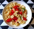 Bowl of fresh pasta with tomatoes, basil and olive oil