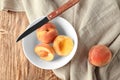 Bowl with fresh peaches and knife on wooden table Royalty Free Stock Photo