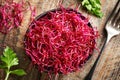 A bowl of fresh red beet sprouts or microgreens with a fork Royalty Free Stock Photo